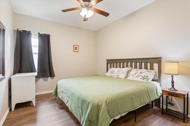 bedroom with baseboards, a ceiling fan, and wood finished floors