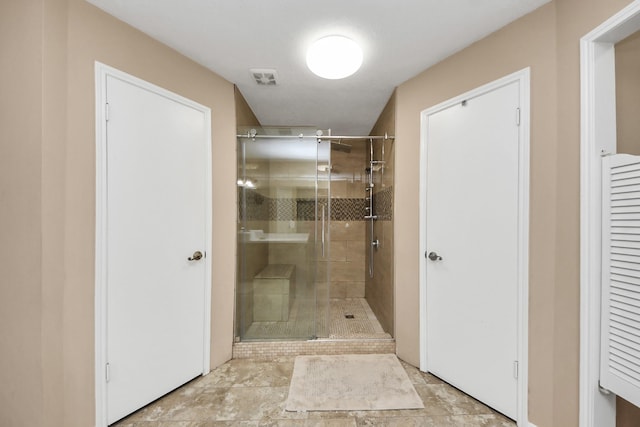 full bath with visible vents and a shower stall
