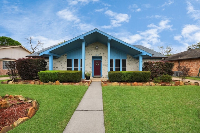 mid-century inspired home with brick siding, central air condition unit, and a front yard