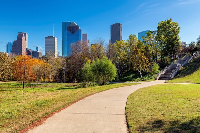 surrounding community featuring a lawn and a view of city