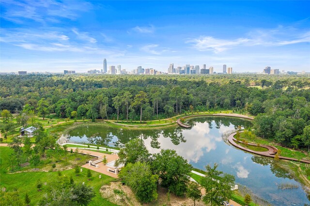 drone / aerial view featuring a city view and a water view