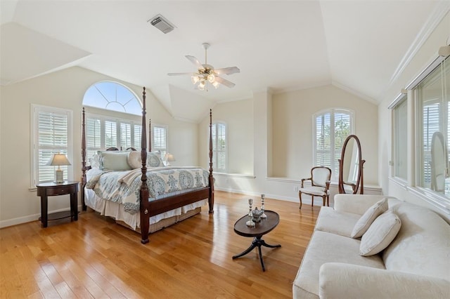 bedroom featuring multiple windows, lofted ceiling, and light wood-type flooring