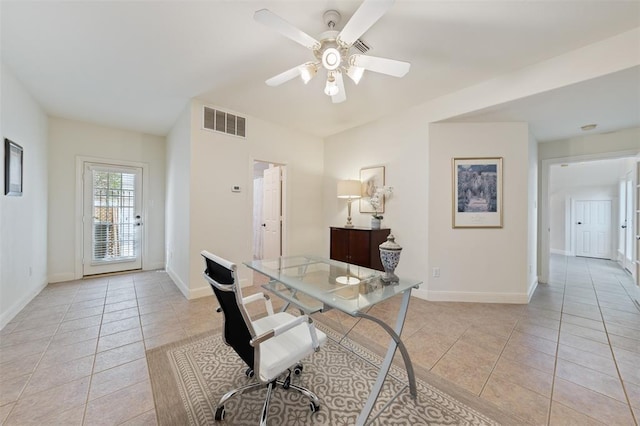 office featuring visible vents, baseboards, ceiling fan, and light tile patterned flooring
