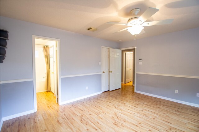 unfurnished bedroom featuring visible vents, baseboards, ceiling fan, and wood finished floors