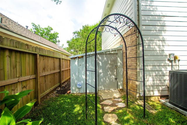 view of yard with fence and cooling unit