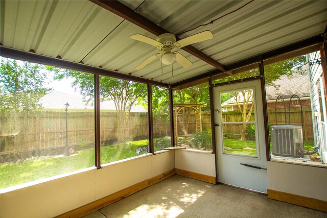 unfurnished sunroom featuring ceiling fan and a healthy amount of sunlight