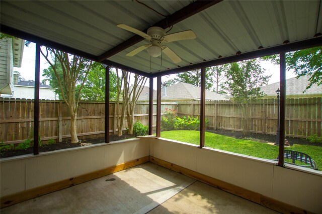 unfurnished sunroom featuring ceiling fan