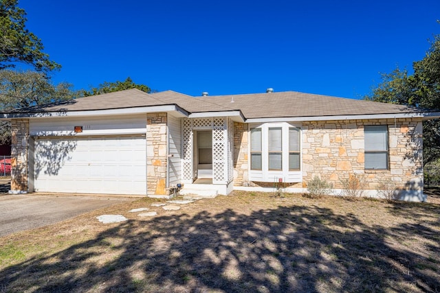 single story home with an attached garage, aphalt driveway, roof with shingles, and stone siding