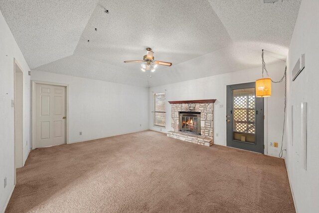 unfurnished living room featuring a fireplace, ceiling fan, a textured ceiling, carpet, and vaulted ceiling
