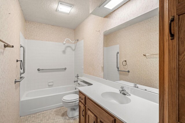 full bath featuring vanity, toilet, wallpapered walls, a textured ceiling, and shower / bathing tub combination