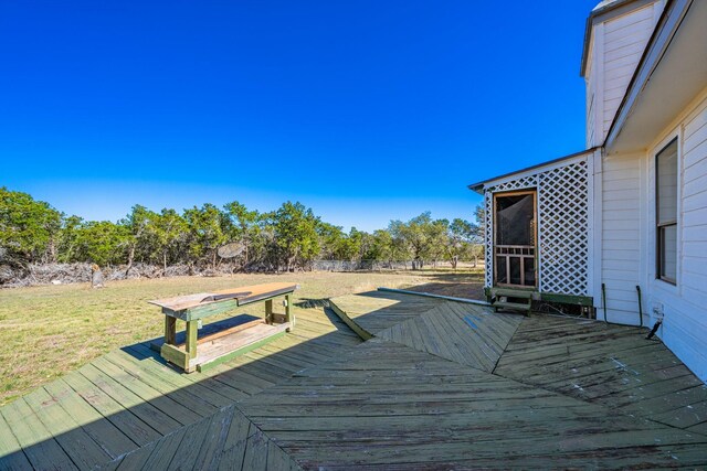wooden terrace featuring a yard