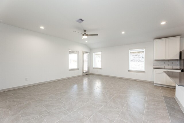 unfurnished living room with a wealth of natural light, a ceiling fan, recessed lighting, and visible vents