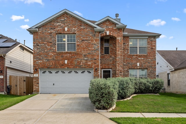 traditional home with a front yard, brick siding, fence, concrete driveway, and an attached garage