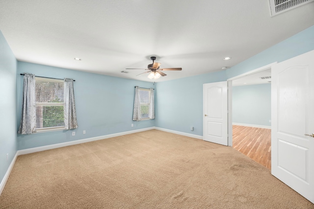 unfurnished room featuring ceiling fan, visible vents, baseboards, carpet flooring, and recessed lighting