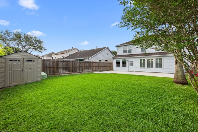 view of yard with a patio, a fenced backyard, a storage unit, and an outdoor structure