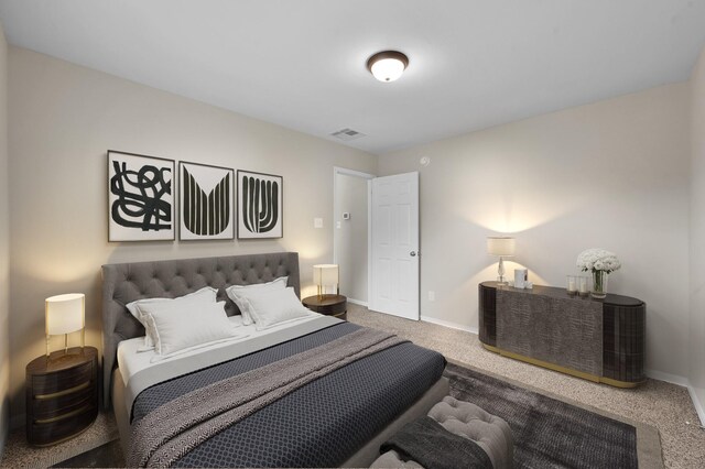 carpeted bedroom with visible vents and baseboards