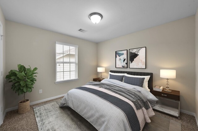 bedroom featuring visible vents, baseboards, and carpet floors