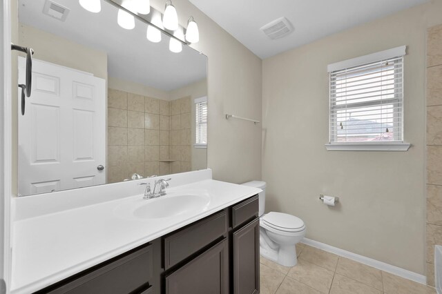 bathroom featuring visible vents, tile patterned floors, toilet, and tiled shower