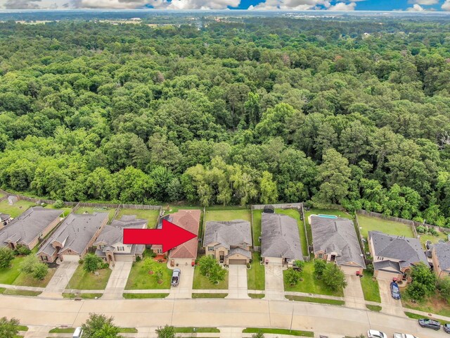 aerial view featuring a residential view and a view of trees