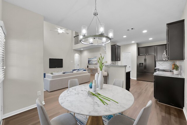 dining room with visible vents, baseboards, and wood finished floors