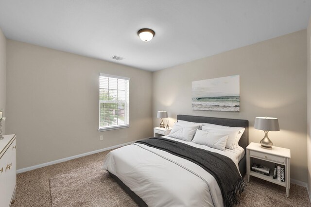 carpeted bedroom featuring visible vents and baseboards