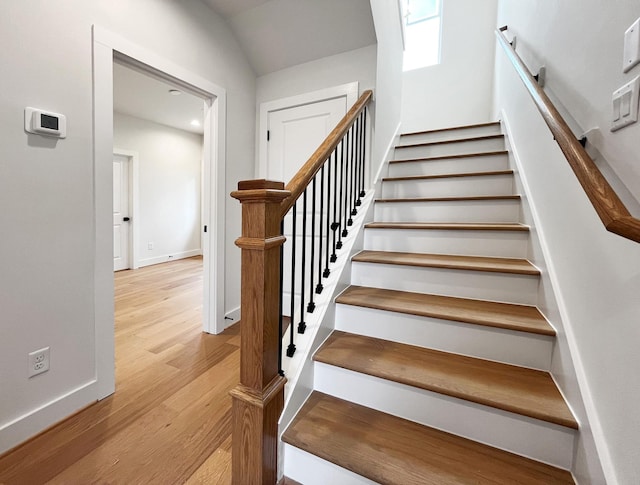 stairs with baseboards and wood finished floors