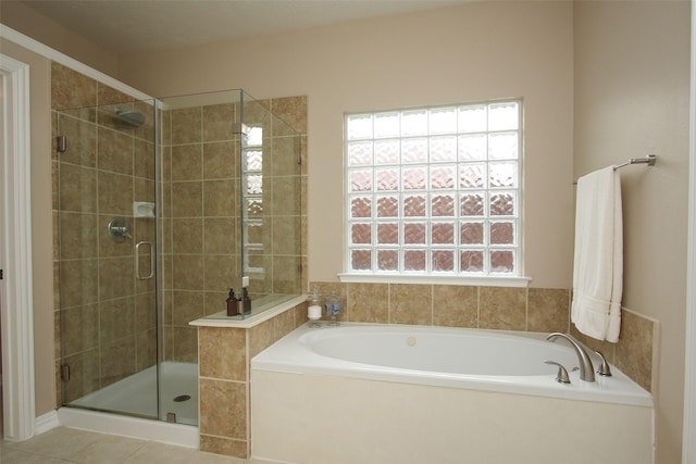 full bathroom featuring tile patterned floors, a stall shower, and a garden tub