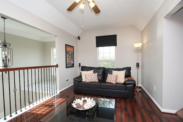 living room featuring baseboards, ceiling fan with notable chandelier, wood finished floors, and lofted ceiling