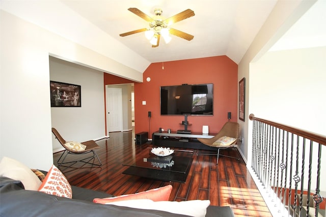 living area featuring vaulted ceiling, baseboards, a ceiling fan, and wood finished floors
