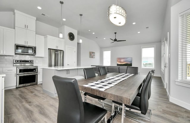 22814 Camino St, Galveston, TX 77554 - dining room with visible vents, lofted ceiling, light wood-style floors, ceiling fan, and recessed lighting