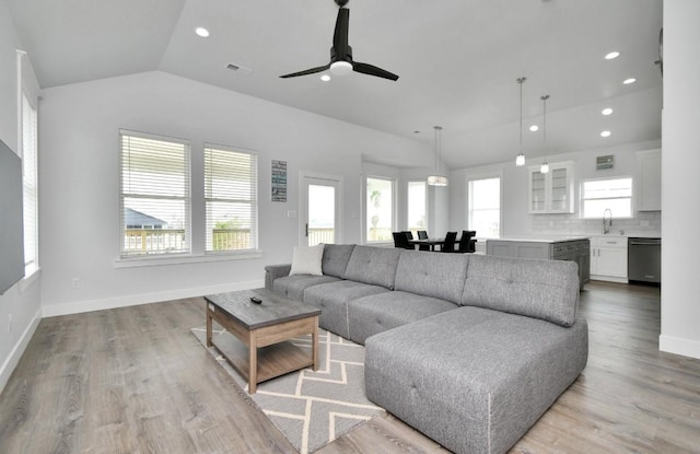 22814 Camino St, Galveston, TX 77554 - living room with recessed lighting, a ceiling fan, vaulted ceiling, and light wood-type flooring