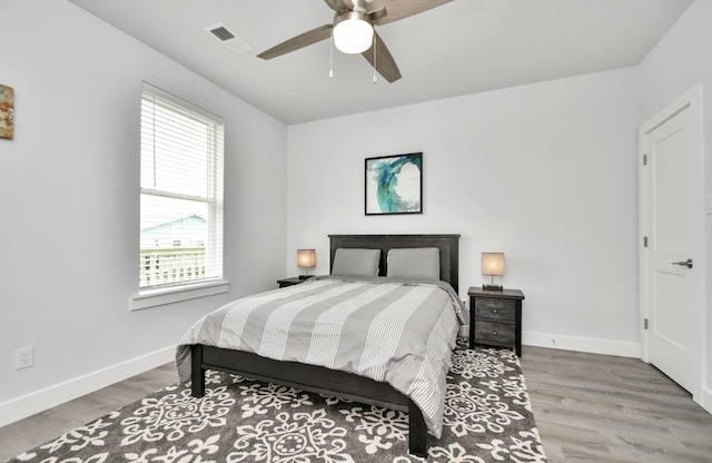 22814 Camino St, Galveston, TX 77554 - bedroom with baseboards, visible vents, multiple windows, and wood finished floors