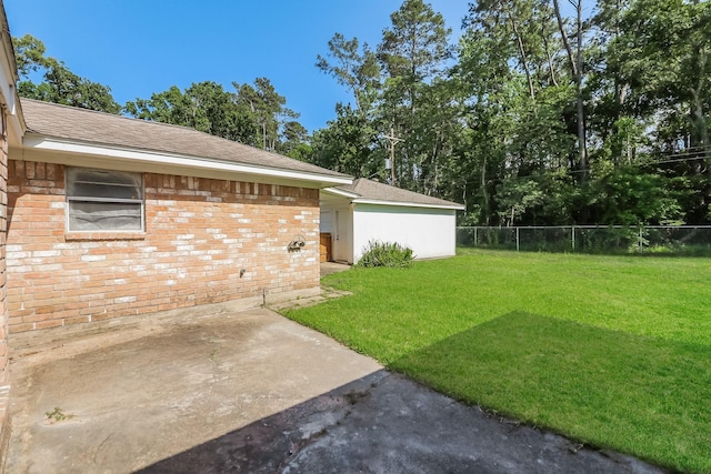 view of yard featuring fence and a patio