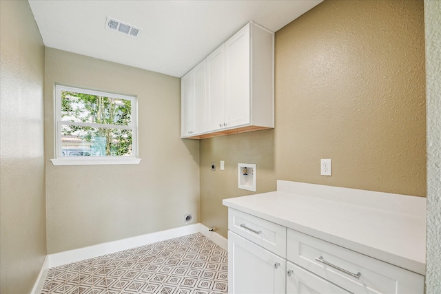 laundry area with visible vents, baseboards, hookup for a washing machine, cabinet space, and hookup for an electric dryer