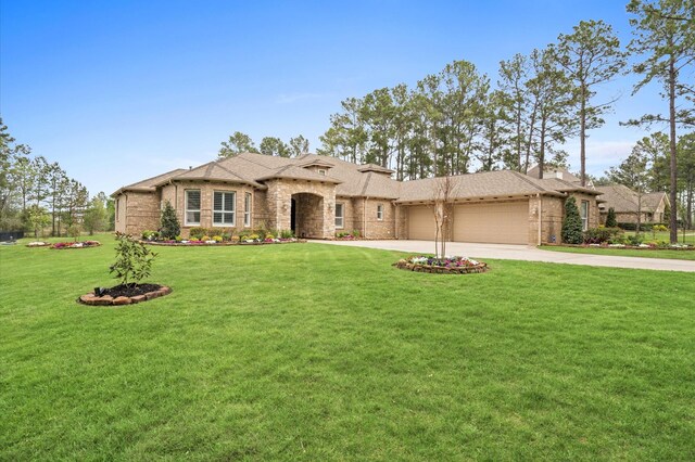 33026 Sawgrass Ct, Magnolia, TX 77354 - view of front of house with a garage, concrete driveway, brick siding, and a front yard