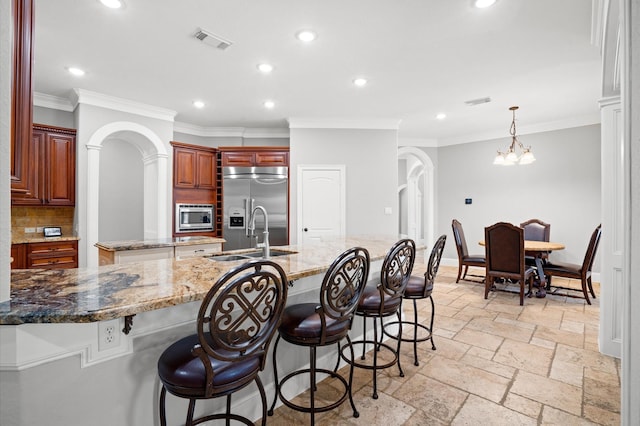 33026 Sawgrass Ct, Magnolia, TX 77354 - kitchen featuring visible vents, crown molding, a sink, built in appliances, and recessed lighting