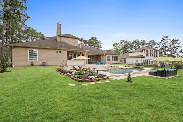 33026 Sawgrass Ct, Magnolia, TX 77354 - back of property featuring a patio, an outdoor pool, a yard, and a chimney