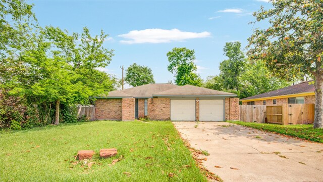 ranch-style house featuring an attached garage, fence, a gate, and a front lawn