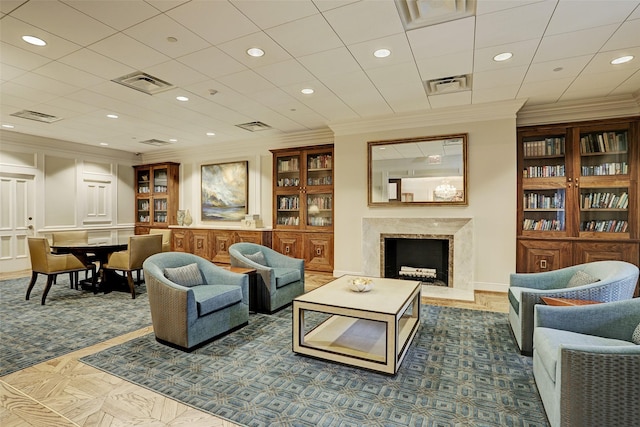 living room with a premium fireplace, recessed lighting, and visible vents