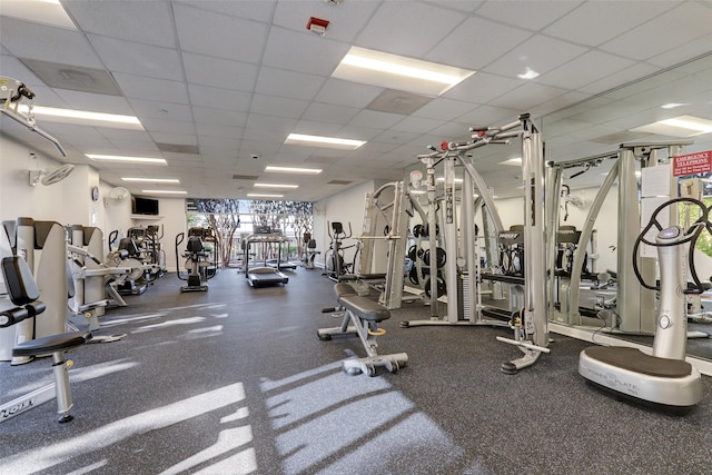 exercise room with a paneled ceiling