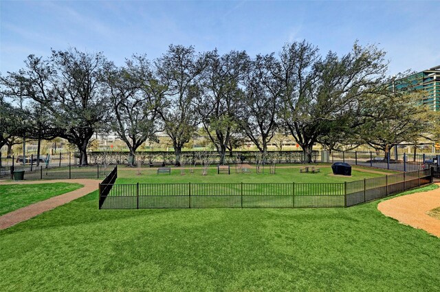 view of community with a yard and fence
