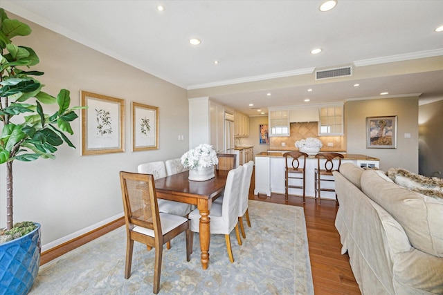 dining room featuring visible vents, recessed lighting, crown molding, and light wood-type flooring
