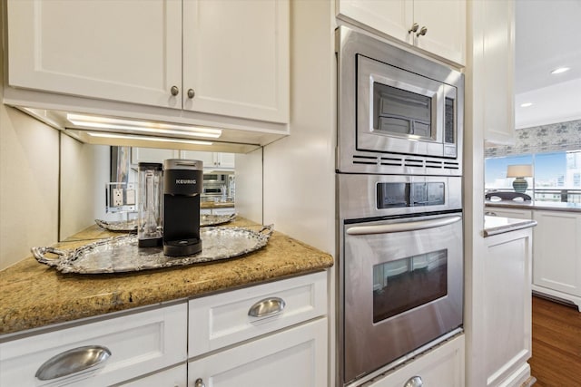 2929 Buffalo Speedway Unit A601, Houston, TX 77098 - kitchen featuring stainless steel appliances, white cabinetry, dark wood-type flooring, light stone countertops, and recessed lighting