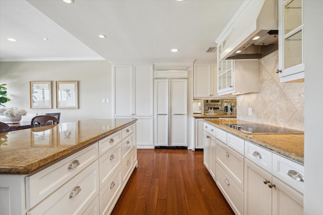 2929 Buffalo Speedway Unit A601, Houston, TX 77098 - kitchen featuring custom range hood, black electric cooktop, dark wood-style flooring, light stone counters, and tasteful backsplash
