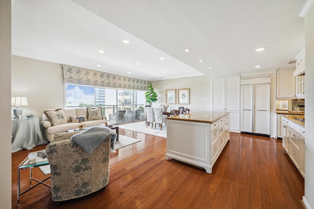 2929 Buffalo Speedway Unit A601, Houston, TX 77098 - kitchen featuring dark wood finished floors, crown molding, white cabinets, a center island, and recessed lighting