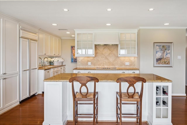 2929 Buffalo Speedway Unit A601, Houston, TX 77098 - kitchen featuring black electric cooktop, a breakfast bar, decorative backsplash, light stone countertops, and recessed lighting