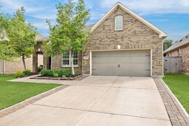 view of front of property with fence, a front yard, driveway, and brick siding