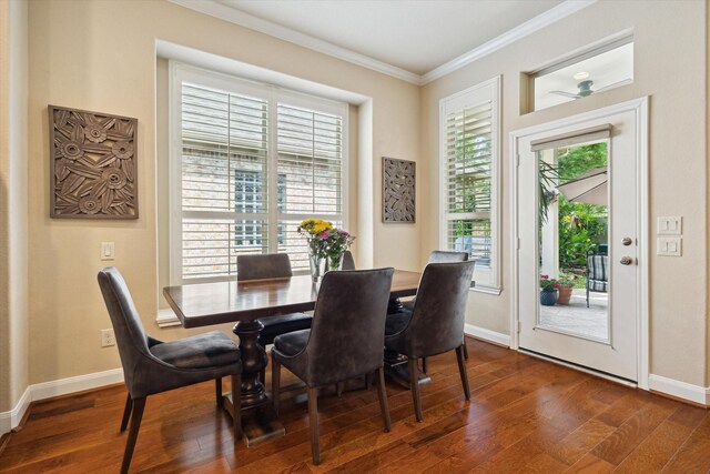 dining space featuring baseboards, ornamental molding, and dark wood-type flooring