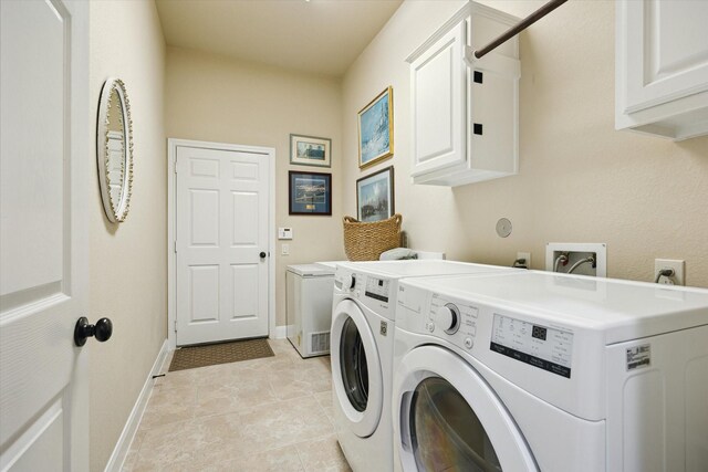 clothes washing area featuring cabinet space, light tile patterned flooring, baseboards, and washing machine and dryer