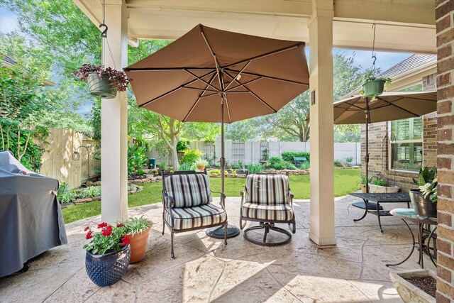 view of patio featuring a fenced backyard and a grill